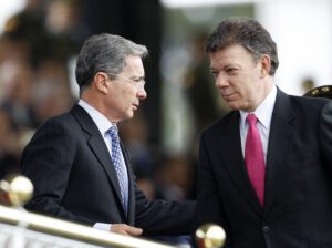 Colombian President Uribe speaks with Defense Minister Santos during an army ceremony at Police School in Bogota